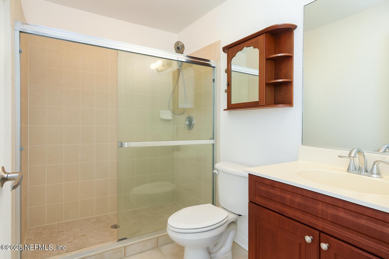 9745 Touchton Road, Unit 1701 Jacksonville, FL 32246 - Photo 15 of 30 a bathroom with a sink a mirror a toilet and shower
