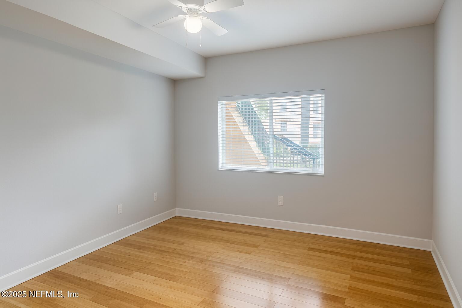 9745 Touchton Road, Unit 1701 Jacksonville, FL 32246 - Photo 17 of 30 an empty room with wooden floor and windows