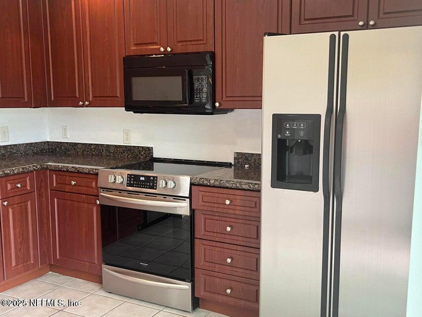 9745 Touchton Road, Unit 1701 Jacksonville, FL 32246 - Photo 10 of 30 a kitchen with a stove and a microwave