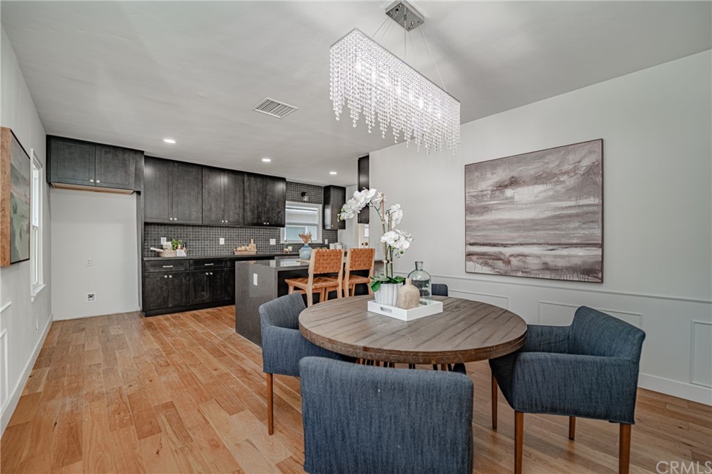 3880 Fairway Boulevard View Park, CA 90043 - Photo 14 of 47 a kitchen with sink refrigerator dining table and chairs