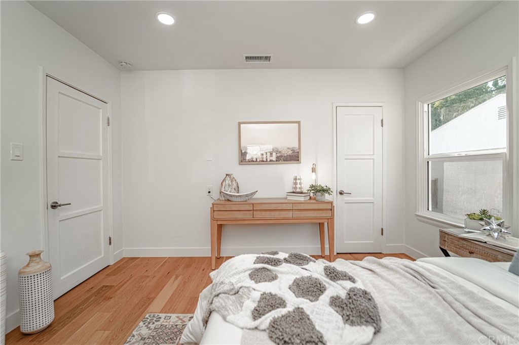 3880 Fairway Boulevard View Park, CA 90043 - Photo 24 of 47 a bedroom with a bed and wooden floor