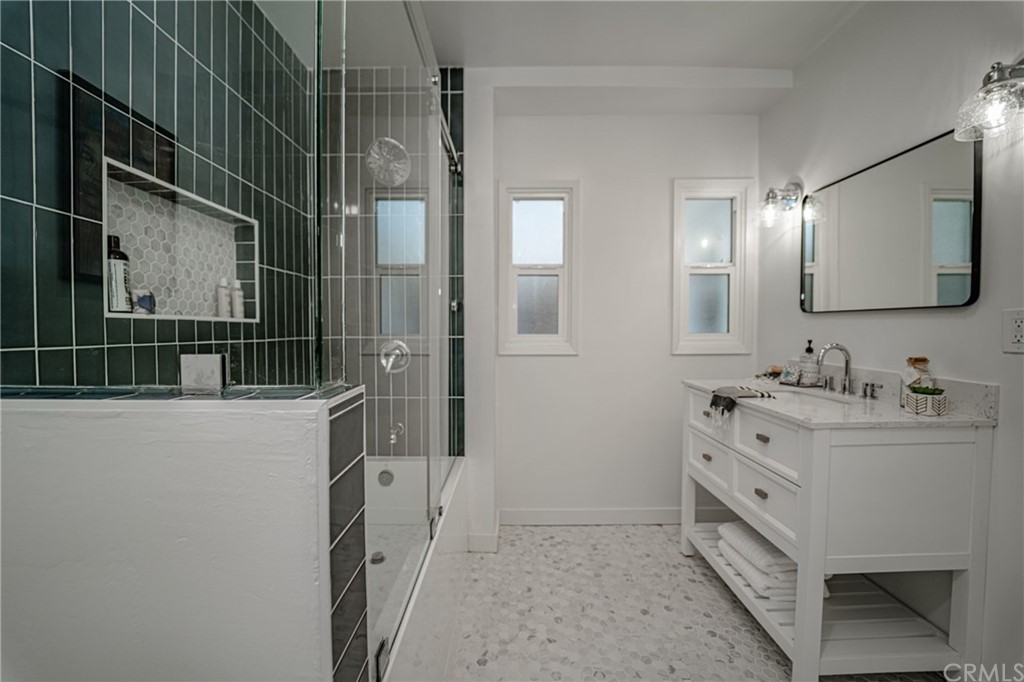 3880 Fairway Boulevard View Park, CA 90043 - Photo 25 of 47 a bathroom with a double vanity sink and mirror