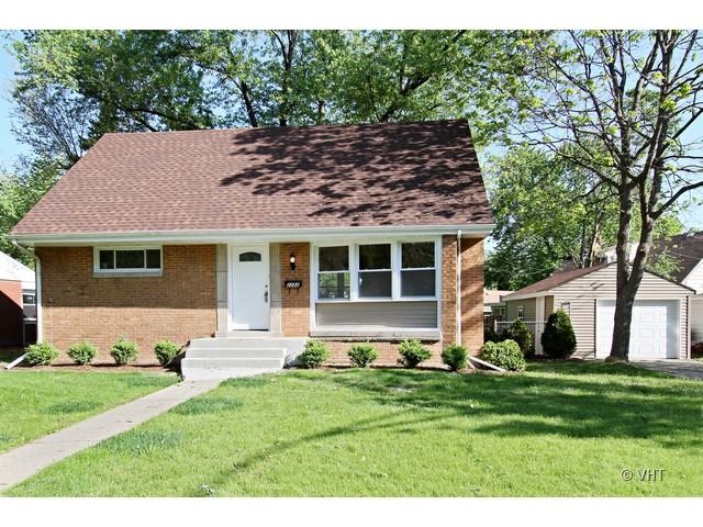 a front view of a house with a yard and porch