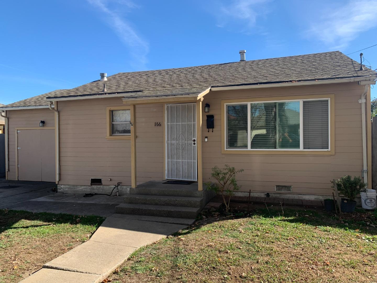 166 Afton Road Salinas, CA 93905 - Photo 3 of 22 a view of a house with a small yard and wooden floor and fence
