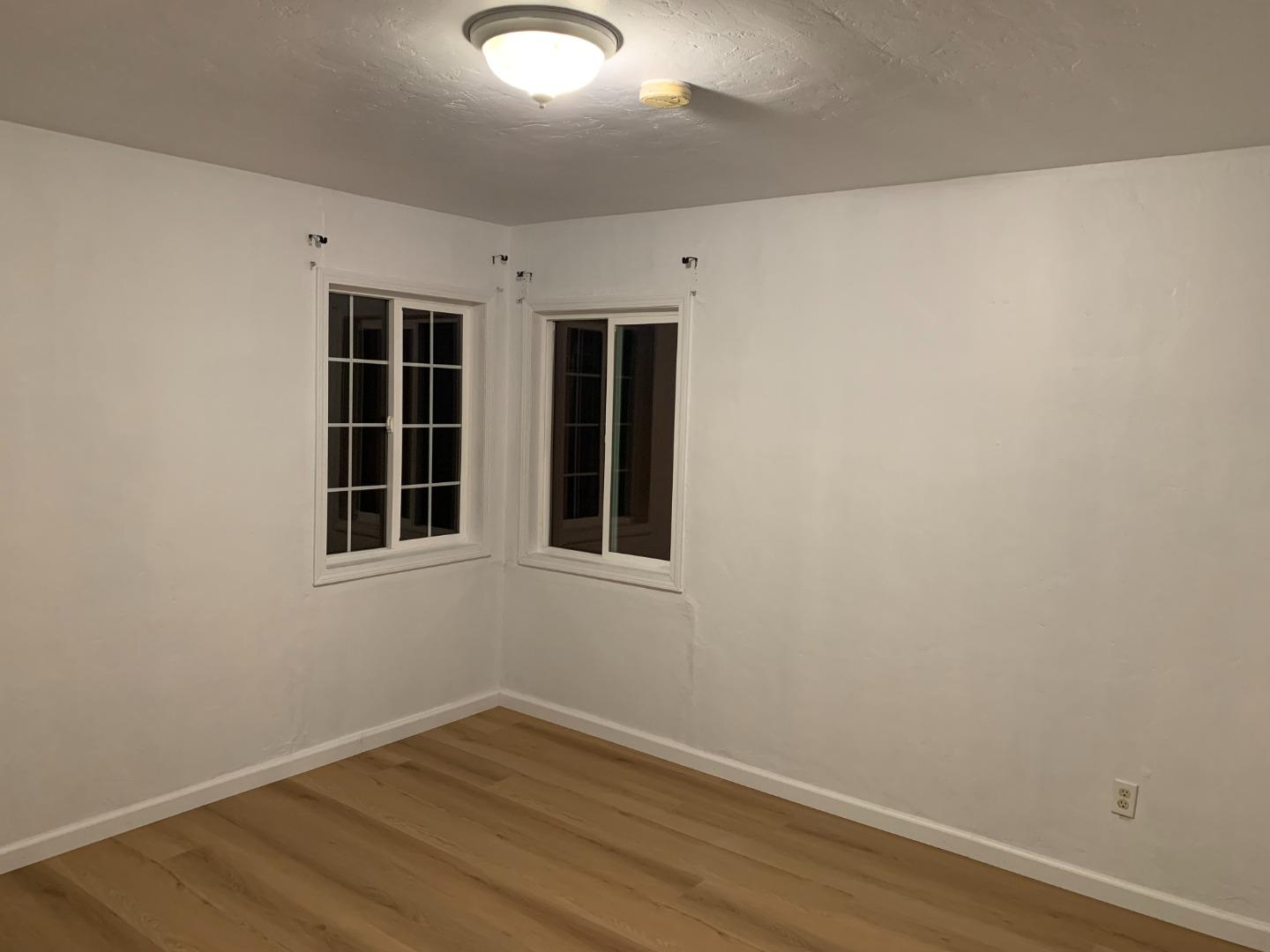 166 Afton Road Salinas, CA 93905 - Photo 4 of 22 an empty room with wooden floor and windows