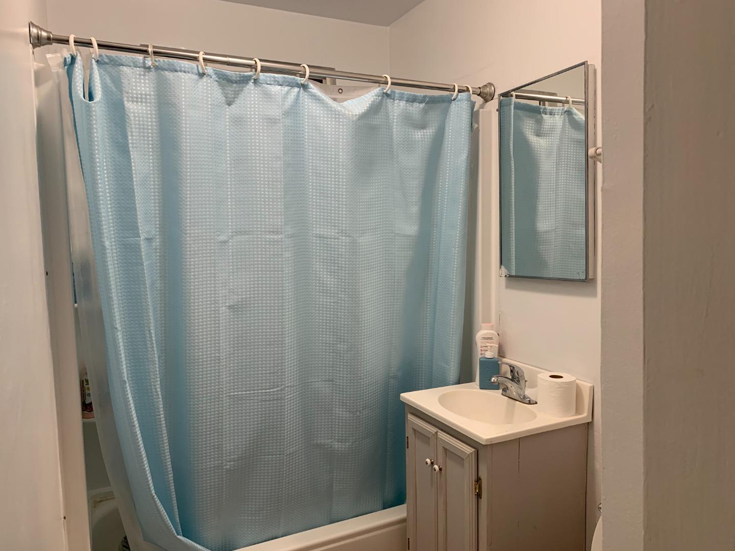 166 Afton Road Salinas, CA 93905 - Photo 6 of 22 a bathroom with a shower and a sink a mirror