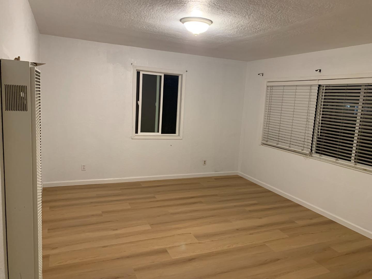 166 Afton Road Salinas, CA 93905 - Photo 8 of 22 a view of an empty room with wooden floor and a window