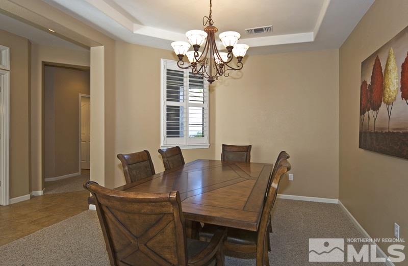 2408 Spring Flower Drive Reno, NV 89521 - Photo 8 of 19 a view of a dining room with furniture and chandelier