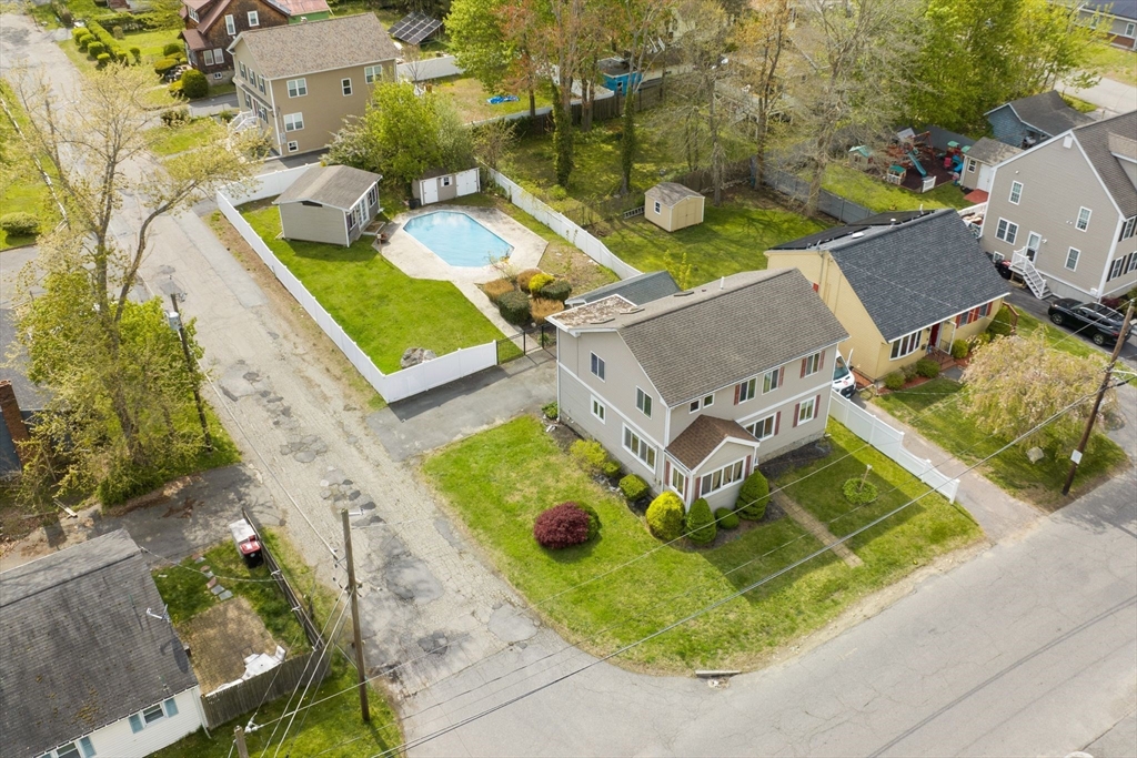 an aerial view of a house with backyard