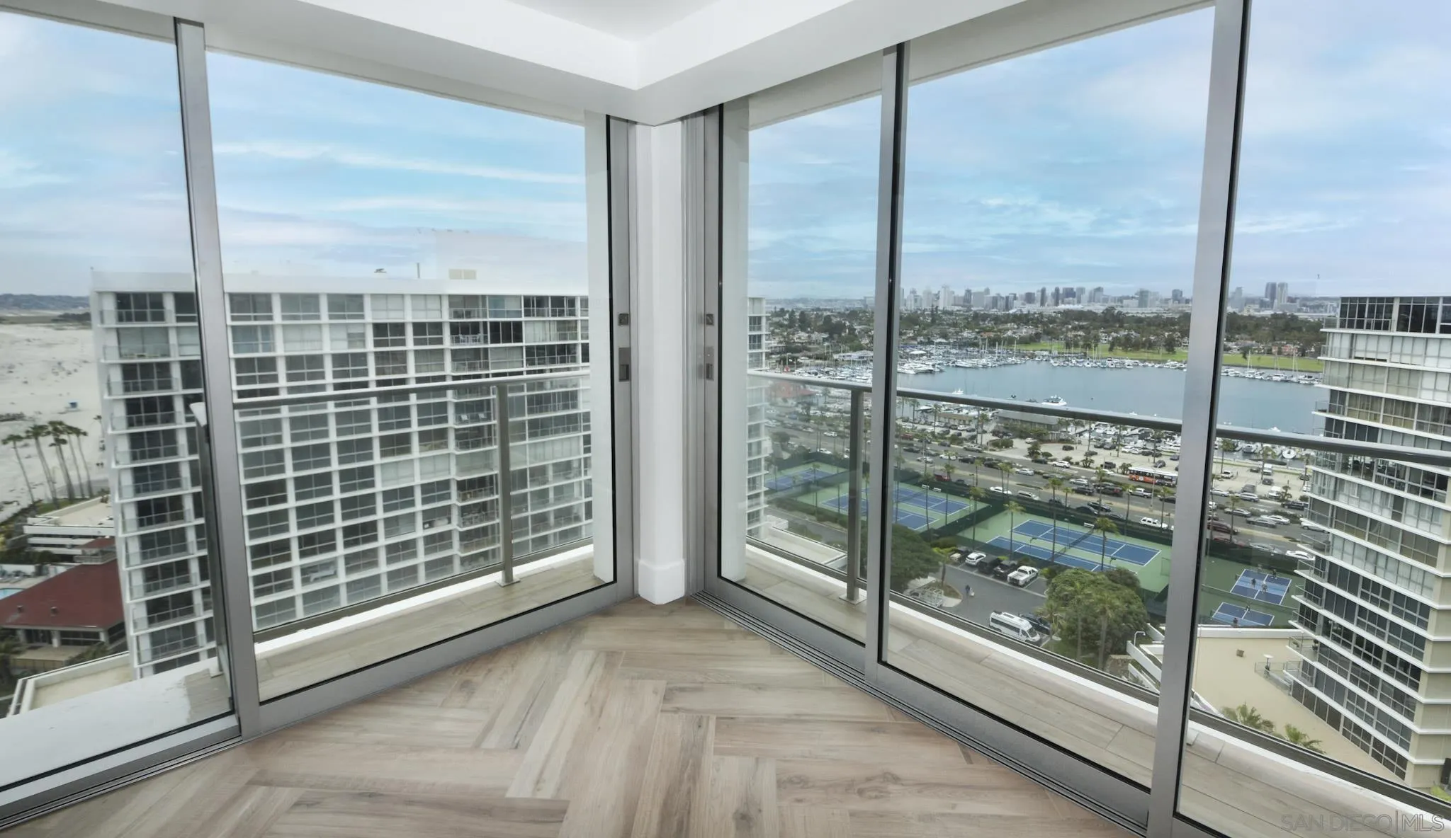 a view of a city from a glass door