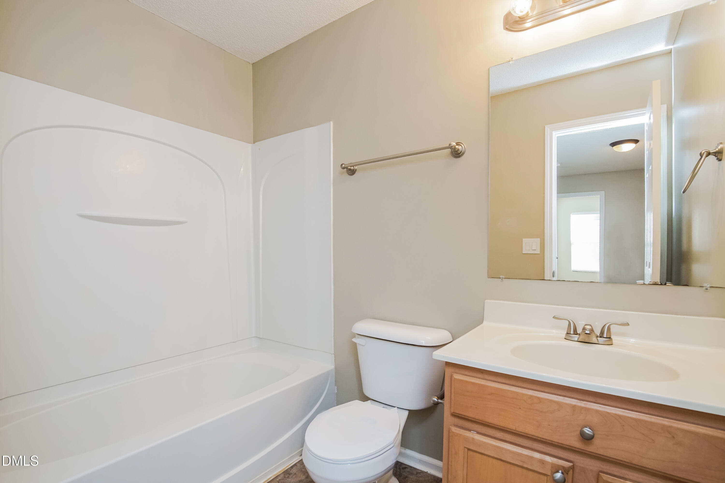 71 Brookhaven Drive Clayton, NC 27527 - Photo 13 of 17 a bathroom with a sink a toilet and a bathtub