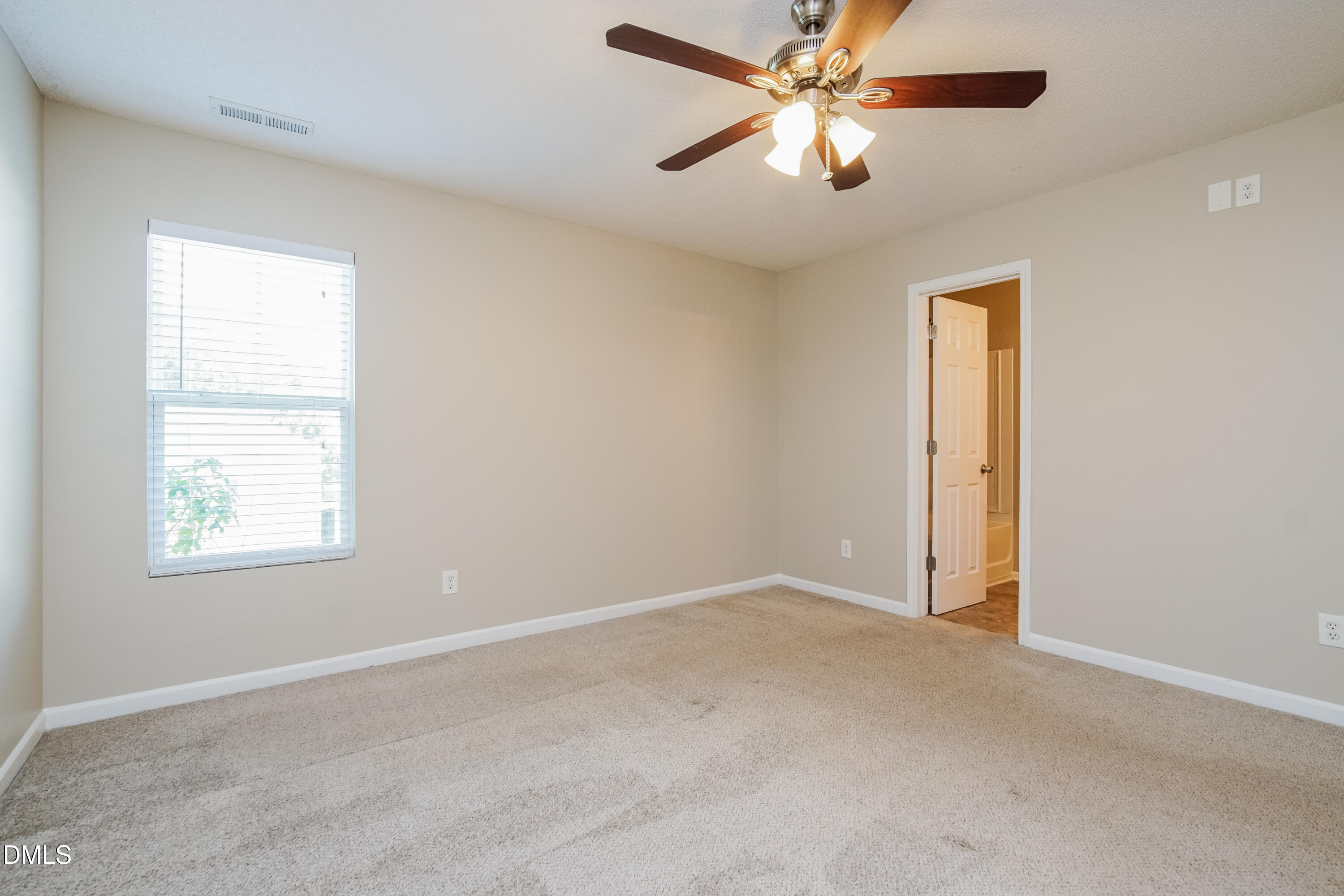 71 Brookhaven Drive Clayton, NC 27527 - Photo 7 of 17 an empty room with windows and fan