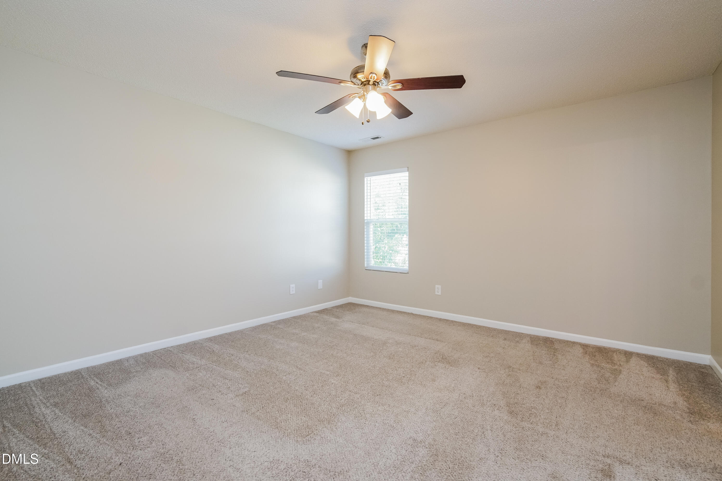 71 Brookhaven Drive Clayton, NC 27527 - Photo 8 of 17 an empty room with windows and fan