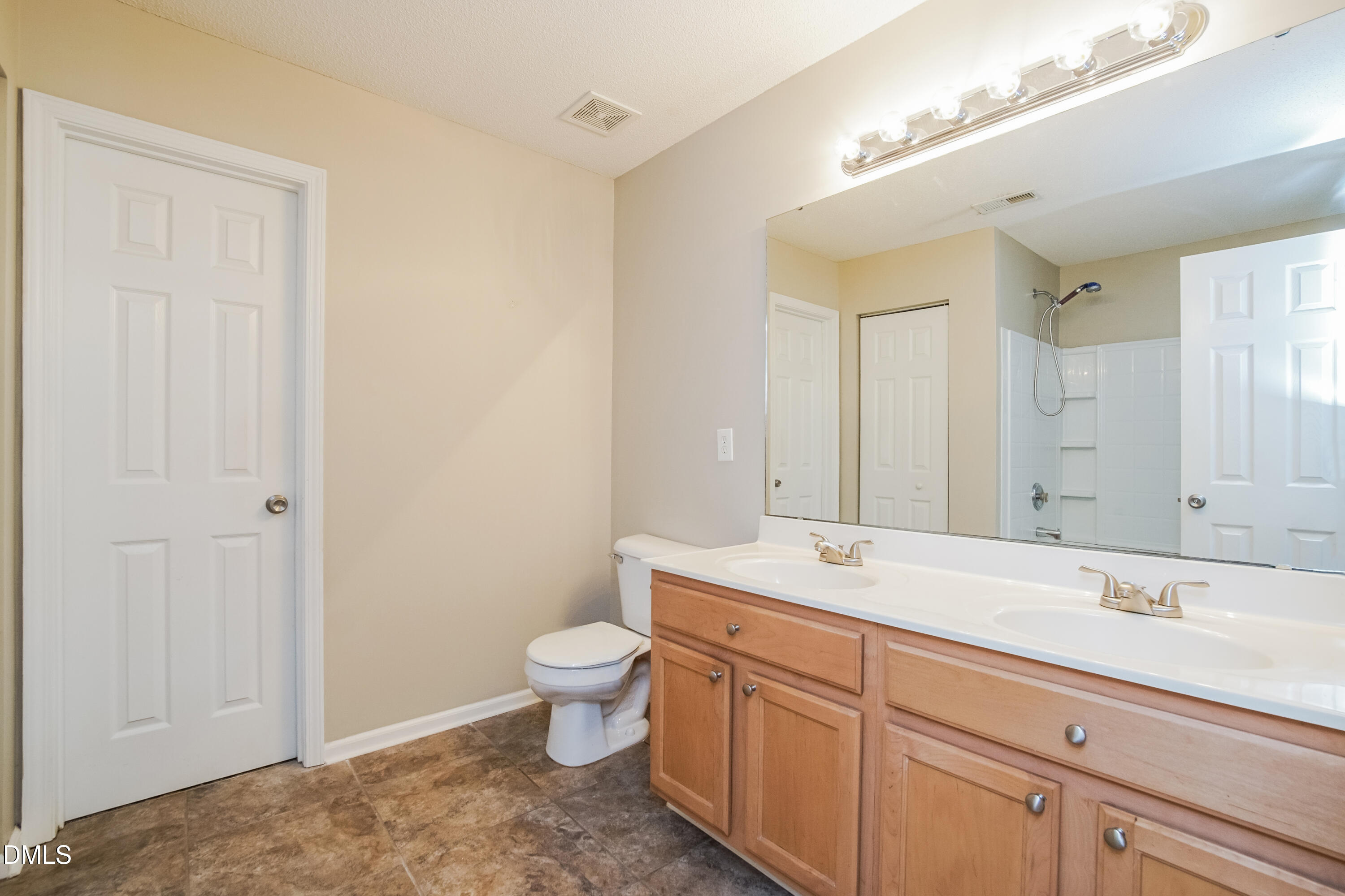 71 Brookhaven Drive Clayton, NC 27527 - Photo 9 of 17 a spacious bathroom with a granite countertop sink a toilet and a mirror