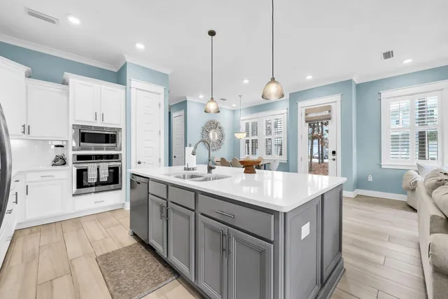 a kitchen with a sink and a stove top oven