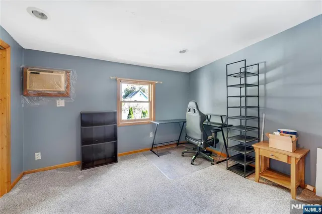 a view of a workspace with furniture and a window