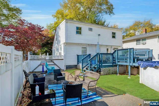 a view of a patio with table and chairs potted plants and a palm tree