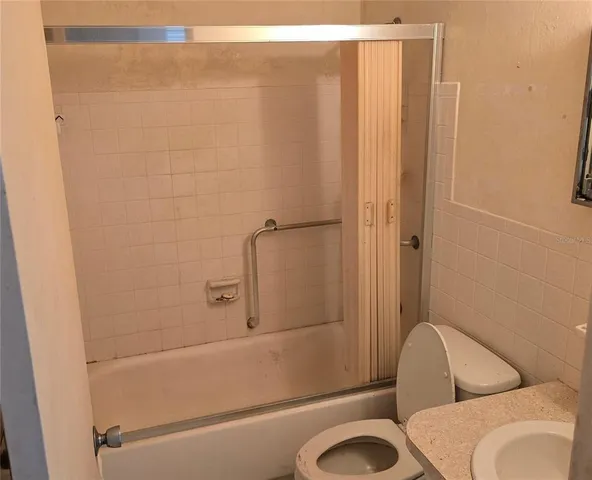 a bathroom with a toilet a sink and a shower