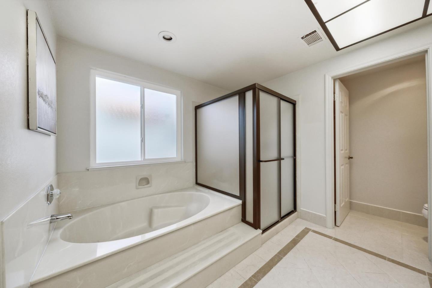 809 Terra Bella Drive Milpitas, CA 95035 - Photo 31 of 53 a bathroom with a tub and a shower
