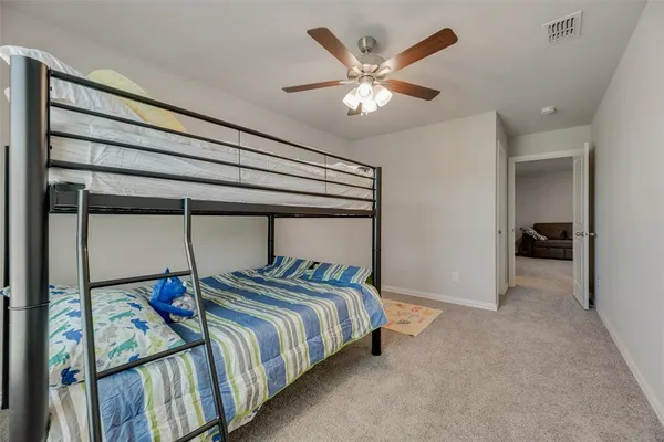 a bedroom with bed and a chandelier
