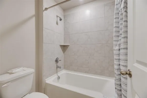 a bathroom with a bathtub and a toilet