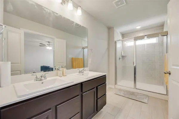 a bathroom with a sink double vanity and shower