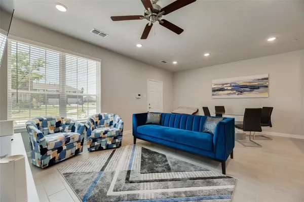 a living room with furniture and a large window