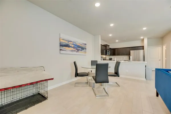 a living room with furniture and kitchen view