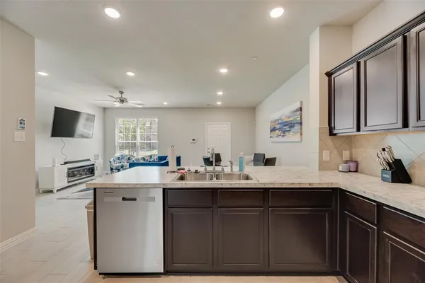 a kitchen with a sink a window and appliances