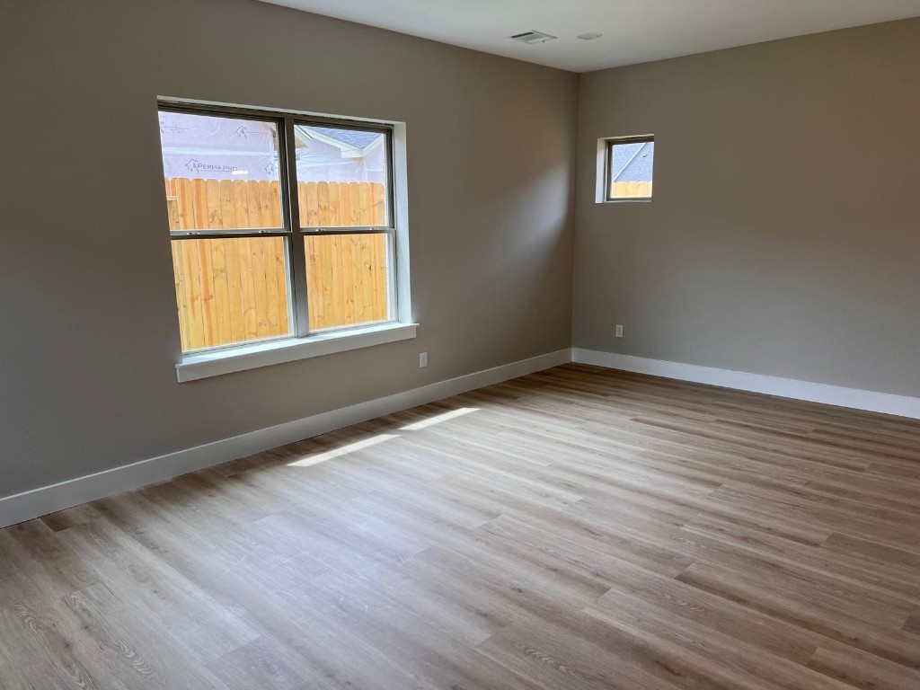 2614 Piemonte Avenue Cir Spring Spring, TX 77388 - Photo 8 of 14 an empty room with wooden floor and windows