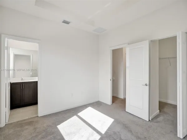 a bathroom with a double vanity sink toilet and shower