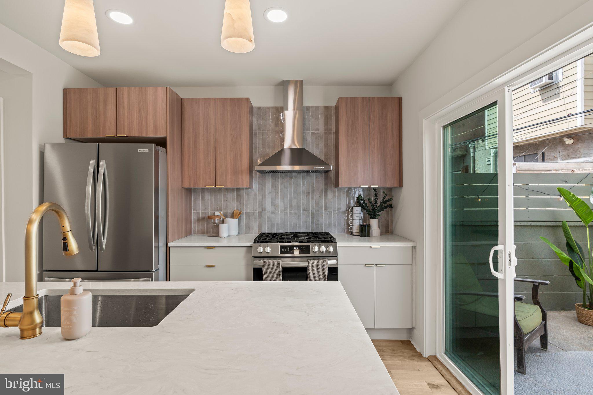 1031 Mercy Street Philadelphia, PA 19148 - Photo 12 of 34 a kitchen with a stove a refrigerator and a sink