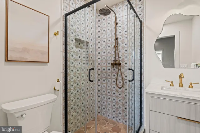 a bathroom with a toilet a sink and a mirror