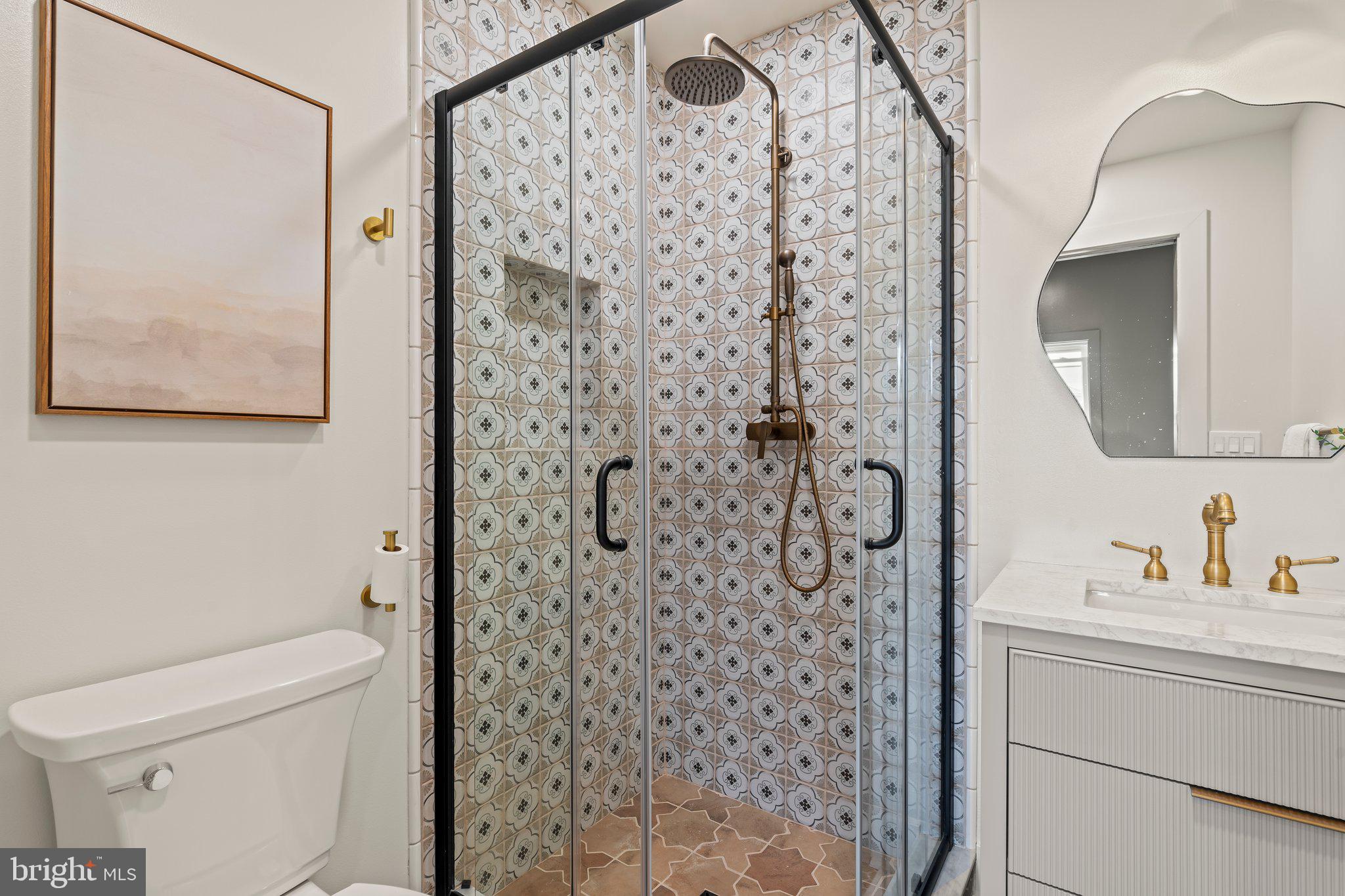 1031 Mercy Street Philadelphia, PA 19148 - Photo 26 of 34 a bathroom with a toilet a sink and a mirror