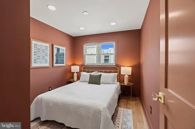 a bedroom with a large bed and a window