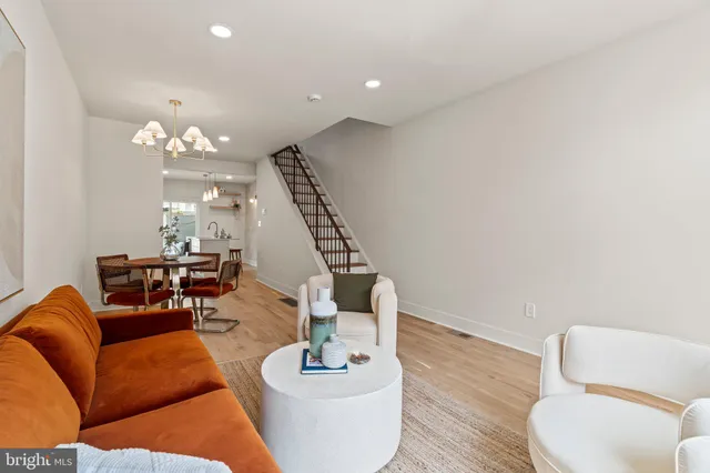 a living room with furniture and a chandelier