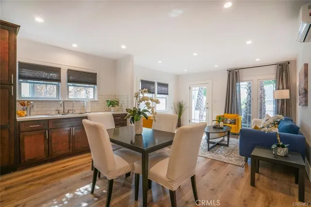 a living room with furniture kitchen view and a window