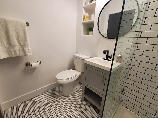 a bathroom with a sink toilet and shower