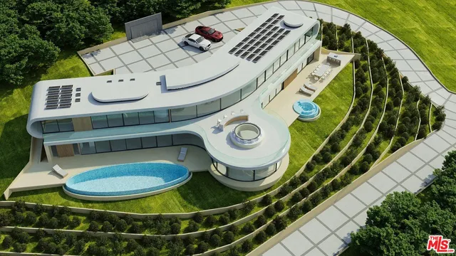 an aerial view of a residential houses with outdoor space and trees