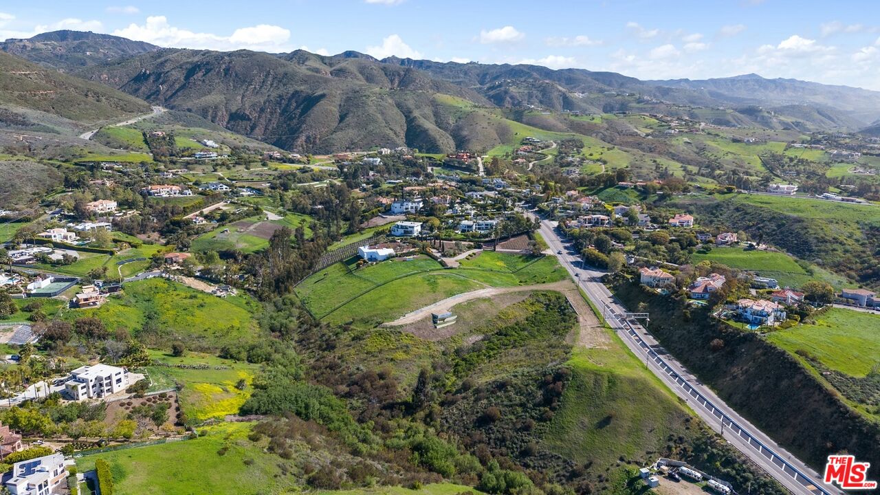 5981 Kanan Dume Road Malibu, CA 90265 - Photo 6 of 10 a view of a lush green hillside and a houses