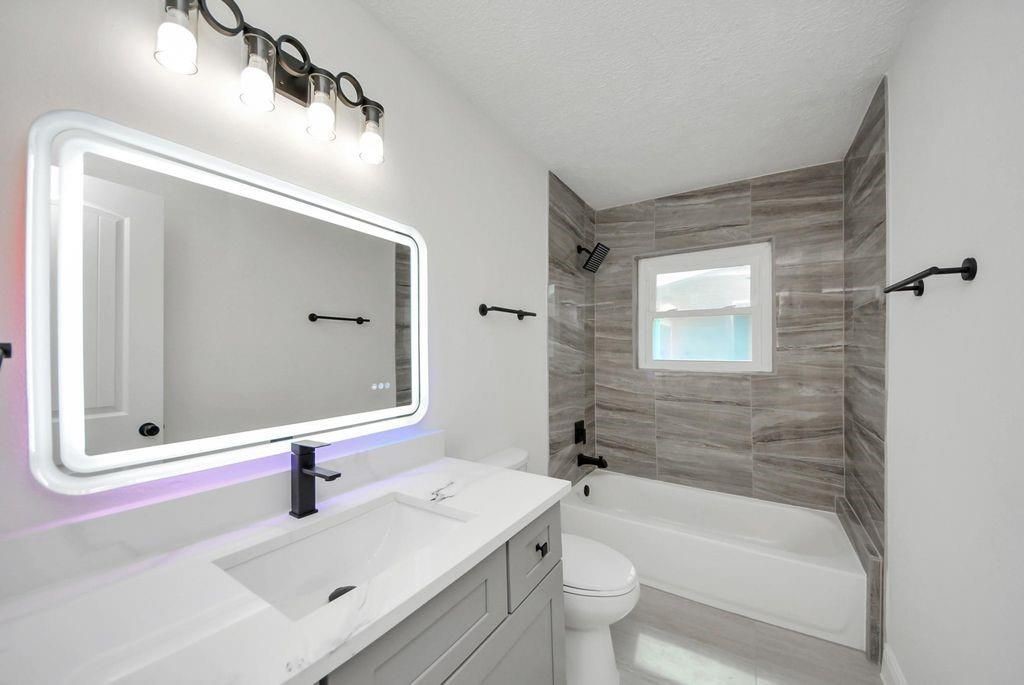 485 Pompano Street Bayou Vista, TX 77563 - Photo 16 of 32 a bathroom with a sink and a mirror