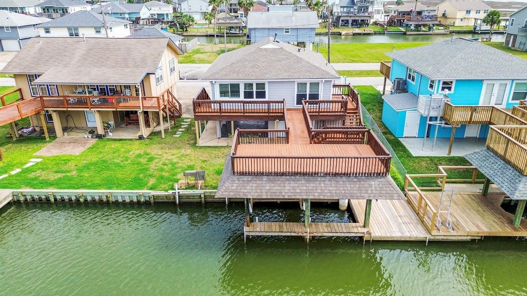 485 Pompano Street Bayou Vista, TX 77563 - Photo 2 of 32 a aerial view of a house with a garden and lake view