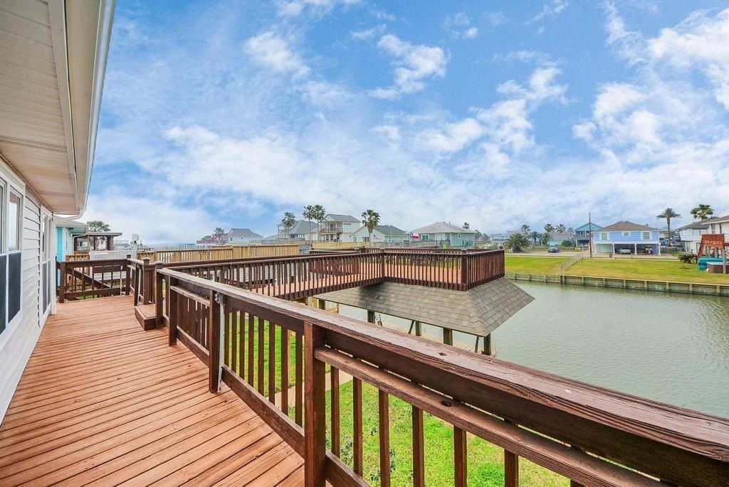 485 Pompano Street Bayou Vista, TX 77563 - Photo 25 of 32 a view of a balcony with wooden chairs and a book shelf