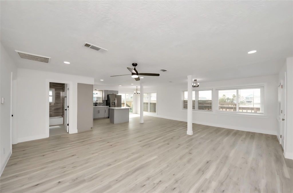 485 Pompano Street Bayou Vista, TX 77563 - Photo 7 of 32 an empty room with wooden floor and windows