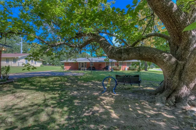 a view of a house with a backyard