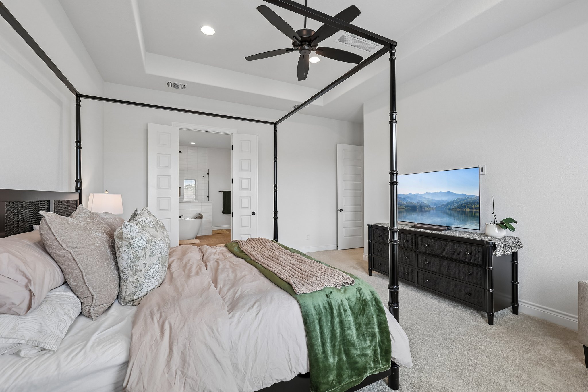 130 Firethorn Loop Bastrop, TX 78602 - Photo 20 of 38 Spacious bedroom featuring a tray ceiling with recessed lighting and a ceiling fan
