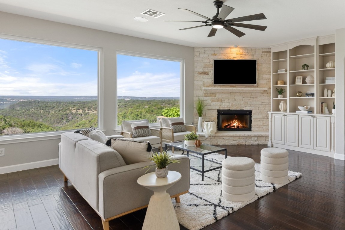 a living room with furniture fireplace and a large window