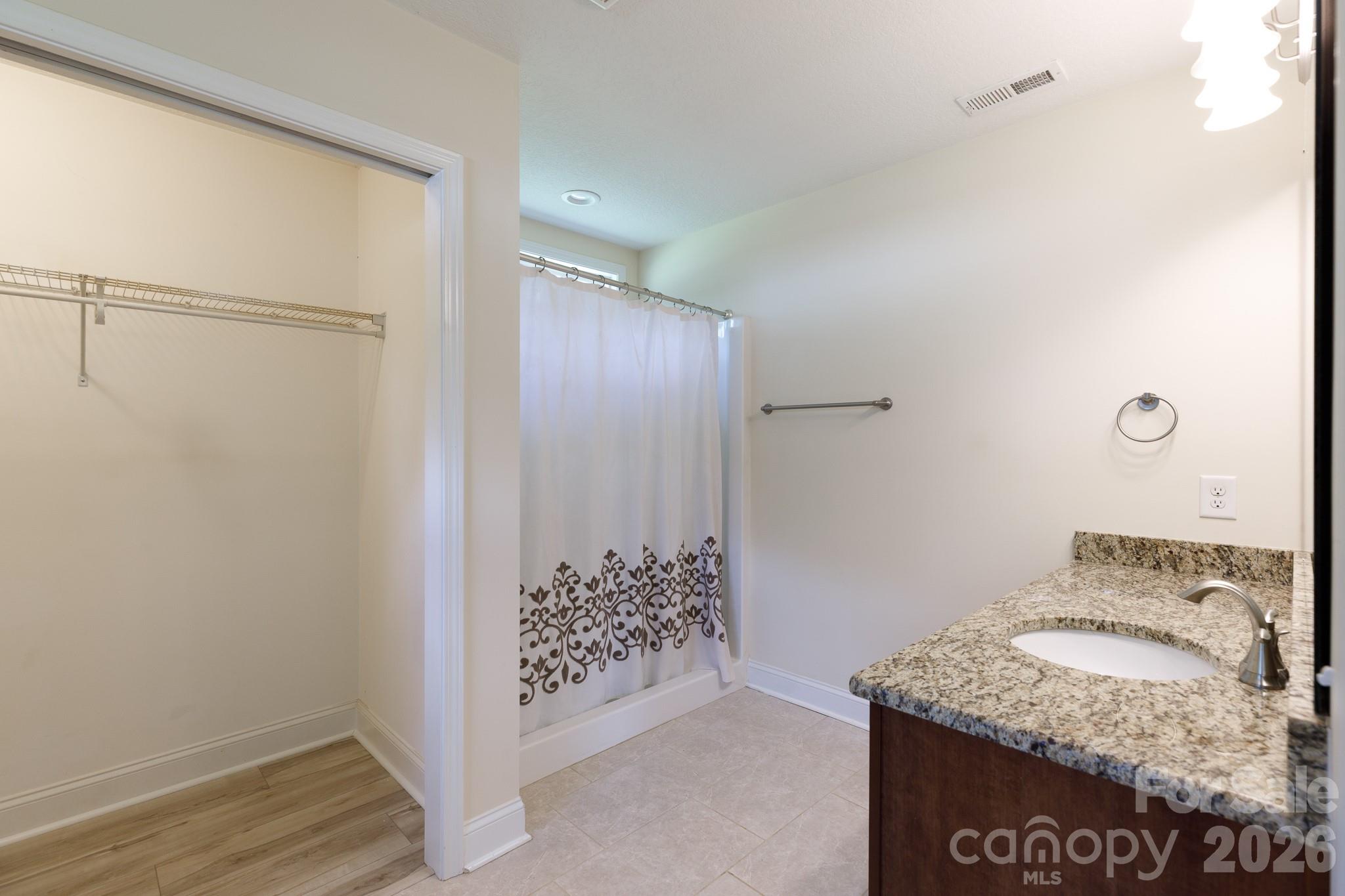 3692 Armstrong Ford Road Rock Hill, SC 29730 - Photo 15 of 30 a bathroom with a granite countertop shower a sink and a toilet