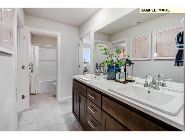 a bathroom with a sink double vanity granite and a mirror