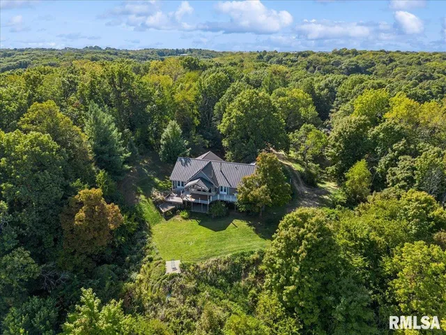 an aerial view of a house with a yard